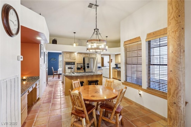 dining space featuring light tile patterned floors and visible vents