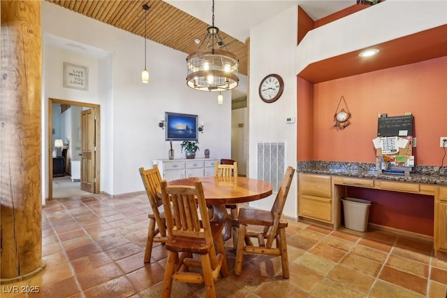 dining area with visible vents, built in study area, wooden ceiling, an inviting chandelier, and high vaulted ceiling