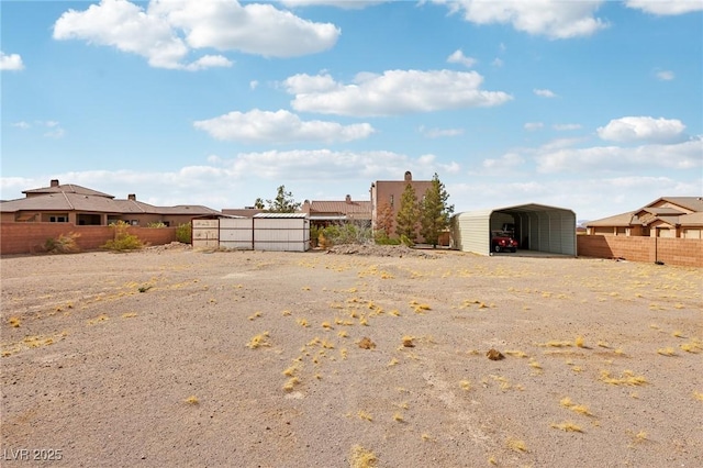 view of yard with fence and a detached carport