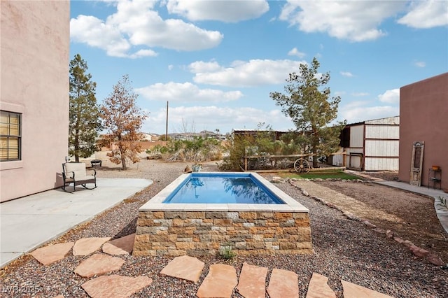 view of pool featuring a patio area