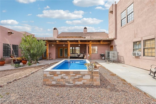 view of pool featuring cooling unit, french doors, and a patio