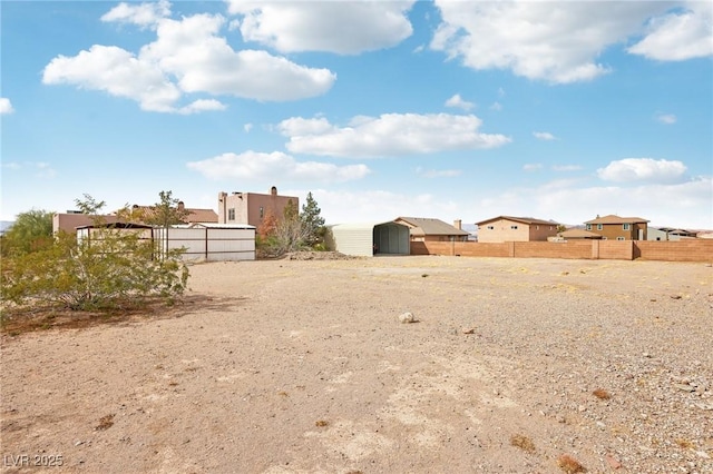 view of yard featuring an outdoor structure and fence