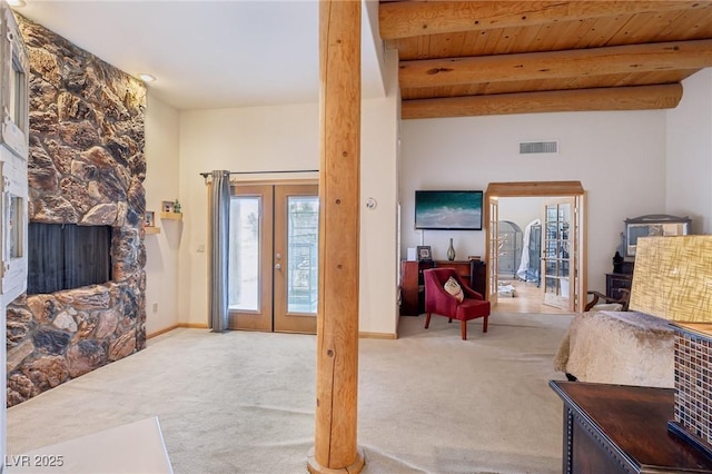 living room featuring french doors, carpet, beam ceiling, and visible vents