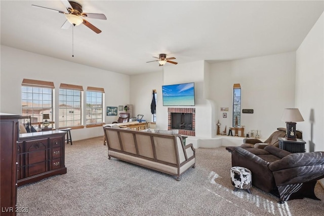 carpeted living area featuring a fireplace and a ceiling fan