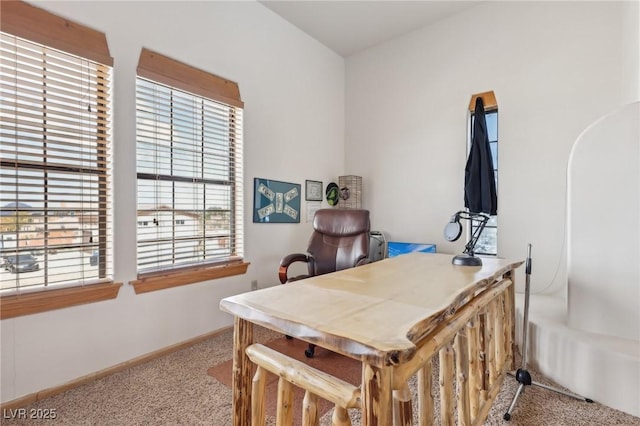 carpeted office space featuring baseboards