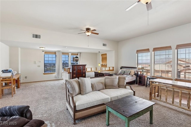 carpeted living room with ceiling fan and visible vents