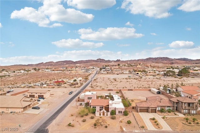 drone / aerial view featuring a residential view, a mountain view, and a desert view