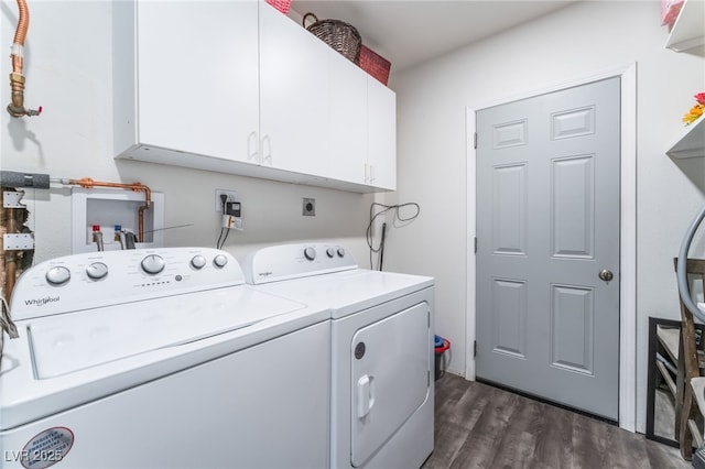 laundry area featuring cabinet space, dark wood-type flooring, and independent washer and dryer