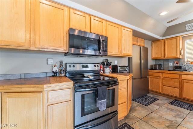 kitchen featuring a toaster, light brown cabinets, visible vents, and stainless steel appliances