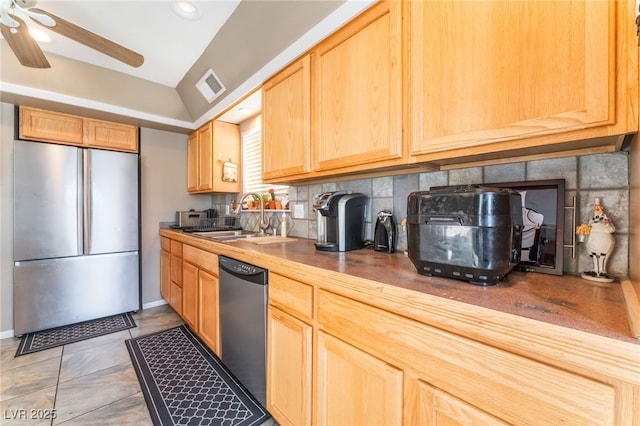 kitchen featuring a sink, visible vents, appliances with stainless steel finishes, backsplash, and light brown cabinetry