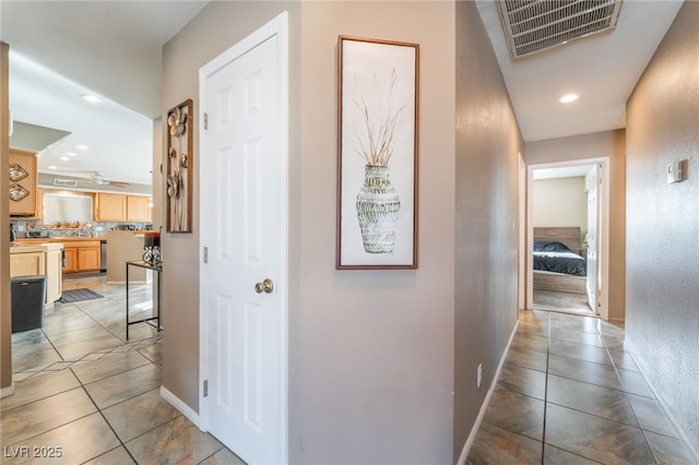 hall with recessed lighting, visible vents, baseboards, and light tile patterned floors