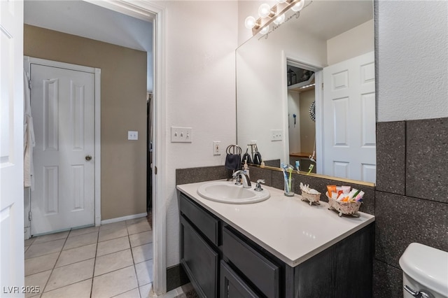 bathroom with vanity, toilet, and tile patterned floors