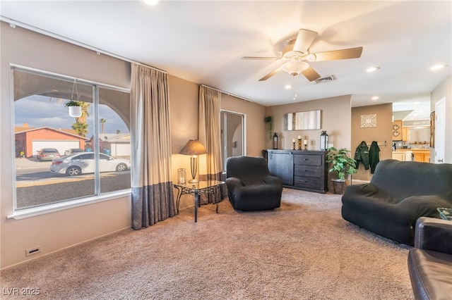 living room featuring recessed lighting, carpet flooring, ceiling fan, and visible vents