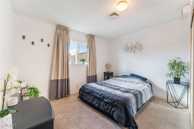 bedroom with visible vents and light colored carpet