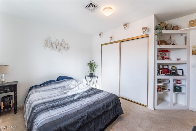 bedroom with carpet, a closet, and visible vents