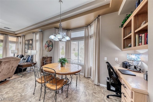 dining space featuring a chandelier, visible vents, a wealth of natural light, and baseboards