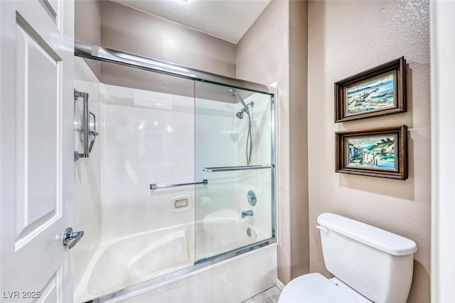 bathroom with enclosed tub / shower combo and toilet