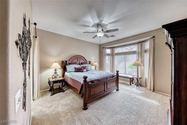 bedroom with light carpet, baseboards, and a ceiling fan