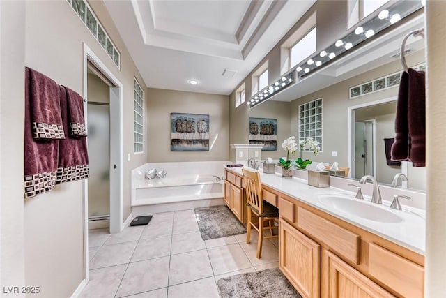 bathroom featuring a raised ceiling, tile patterned floors, a garden tub, vanity, and a shower stall