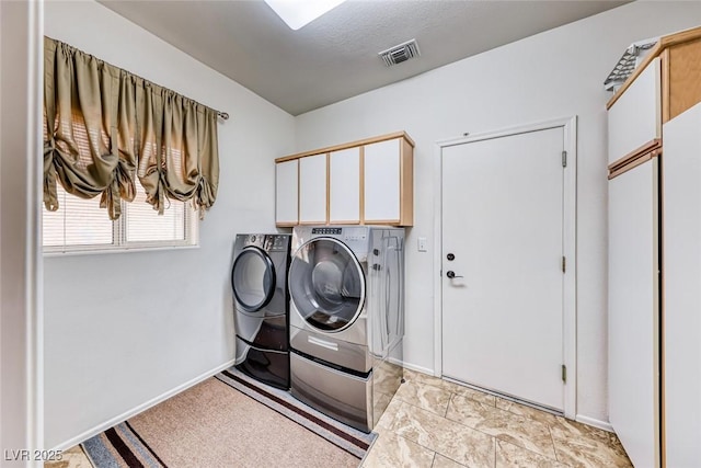 clothes washing area with cabinet space, baseboards, visible vents, washing machine and clothes dryer, and a textured ceiling