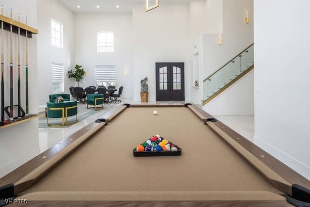 recreation room with recessed lighting, french doors, and a towering ceiling