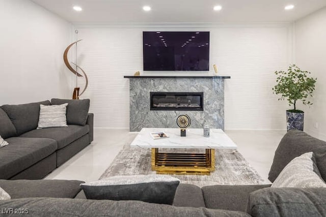 living area featuring a fireplace, crown molding, and recessed lighting