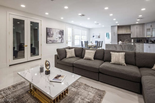 living area featuring recessed lighting, french doors, and baseboards