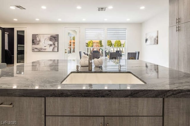 kitchen featuring stone countertops, visible vents, and recessed lighting