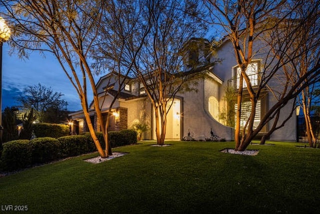 mediterranean / spanish-style house featuring stucco siding and a front yard