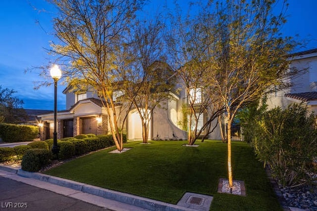 view of front of home featuring a front lawn and stucco siding