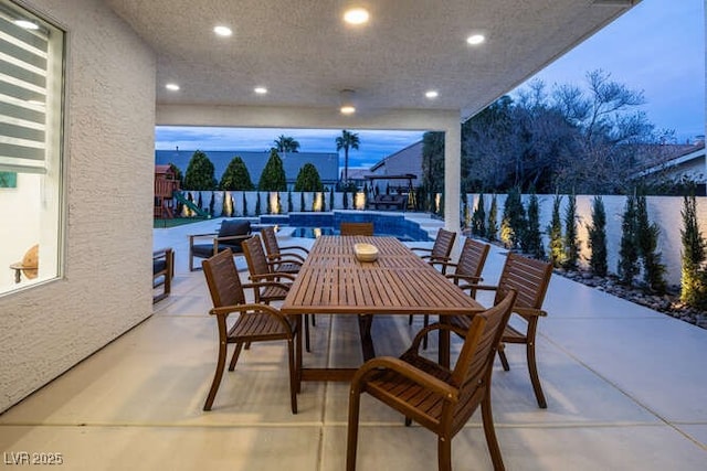 view of patio with a fenced in pool and outdoor dining space