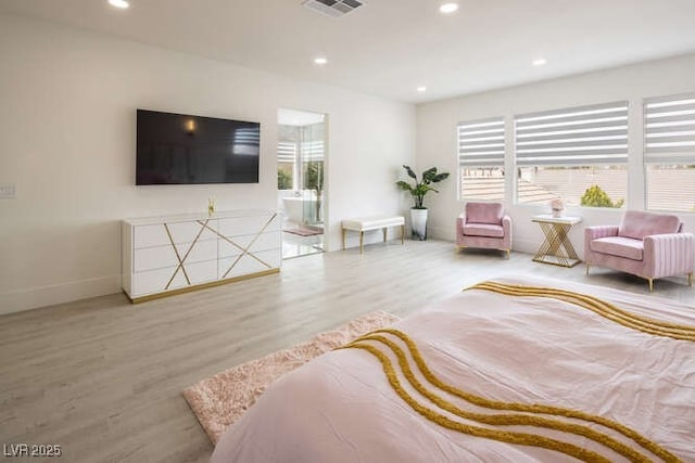 bedroom featuring wood finished floors, visible vents, and recessed lighting