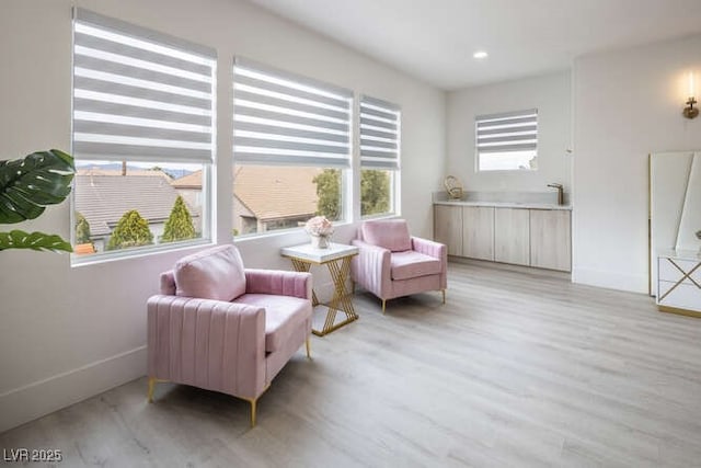 sitting room with recessed lighting, light wood-style flooring, and baseboards