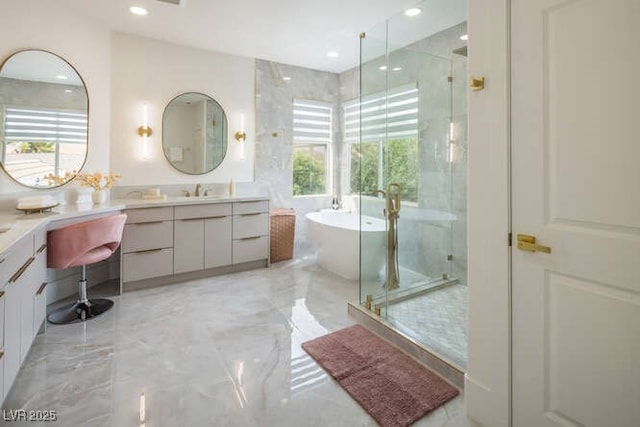 bathroom featuring marble finish floor, a stall shower, and plenty of natural light