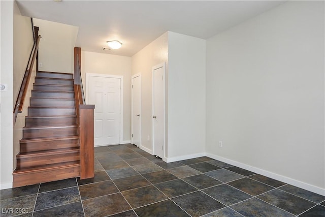 entryway featuring stairway, visible vents, and baseboards