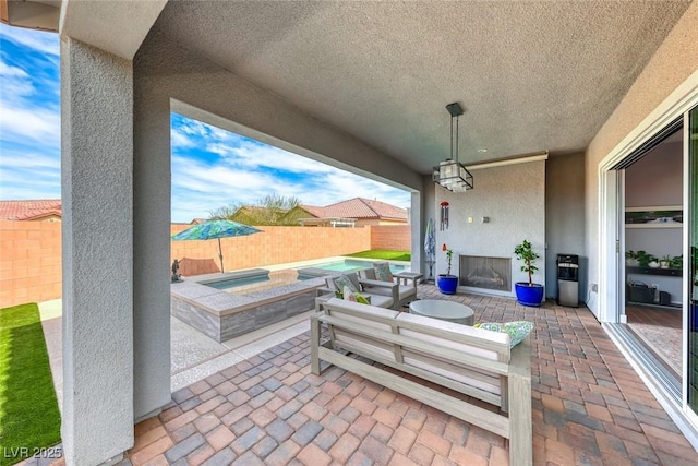 view of patio with a fenced in pool, a fenced backyard, and an in ground hot tub