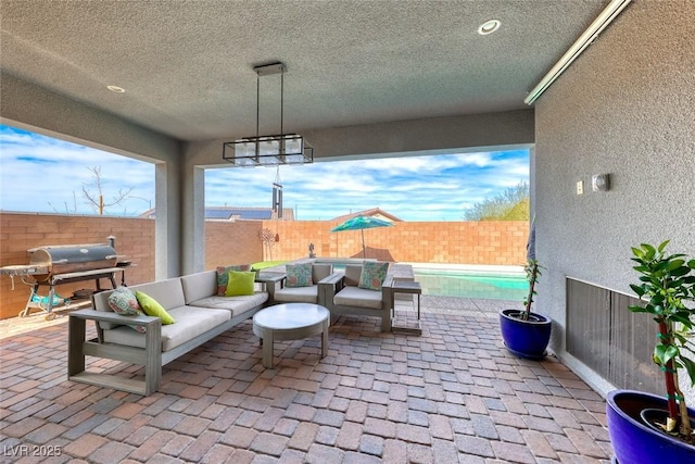 view of patio / terrace featuring a fenced backyard, an outdoor hangout area, and grilling area