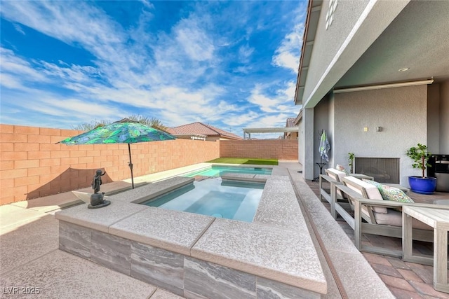 view of swimming pool featuring an in ground hot tub, a patio area, and a fenced backyard