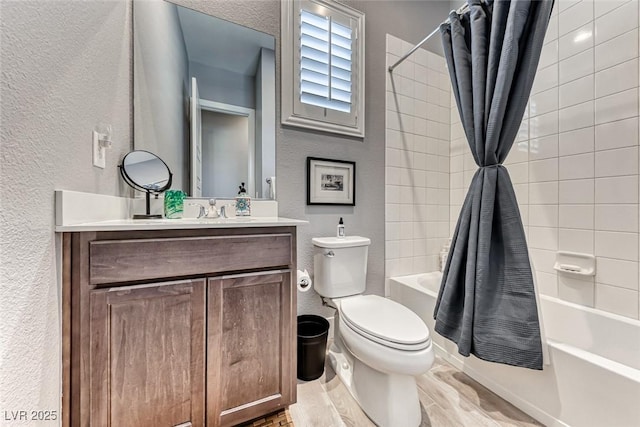 full bath featuring a textured wall, toilet, shower / bath combo with shower curtain, vanity, and wood finished floors