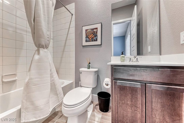 full bath featuring a textured wall, vanity, toilet, and shower / tub combo with curtain