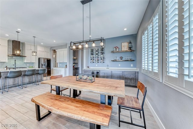 dining area with recessed lighting, beverage cooler, wet bar, and baseboards