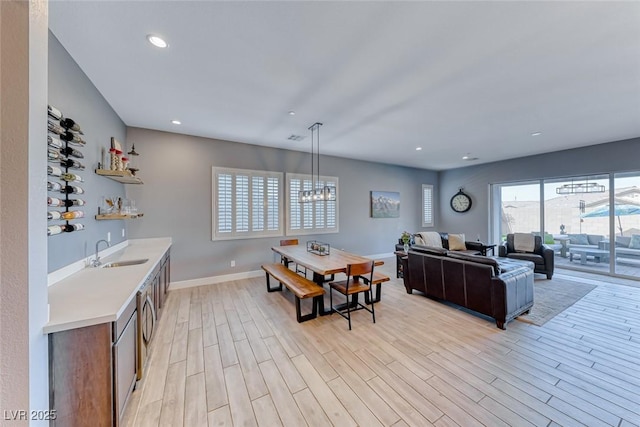 interior space with recessed lighting, visible vents, baseboards, light wood finished floors, and indoor wet bar