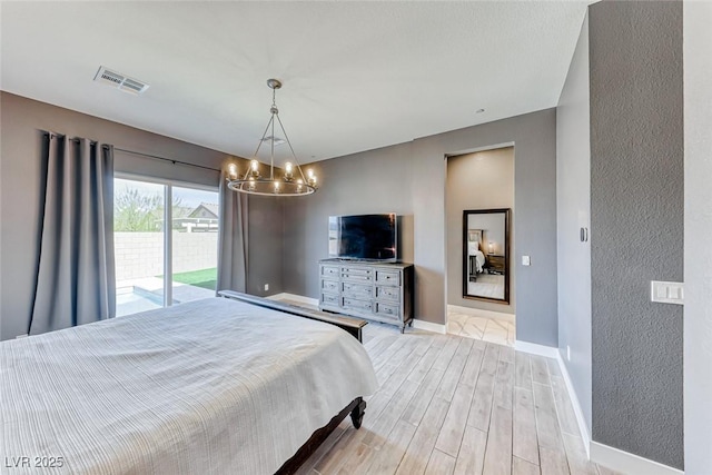 bedroom with baseboards, visible vents, access to exterior, light wood-style floors, and a notable chandelier