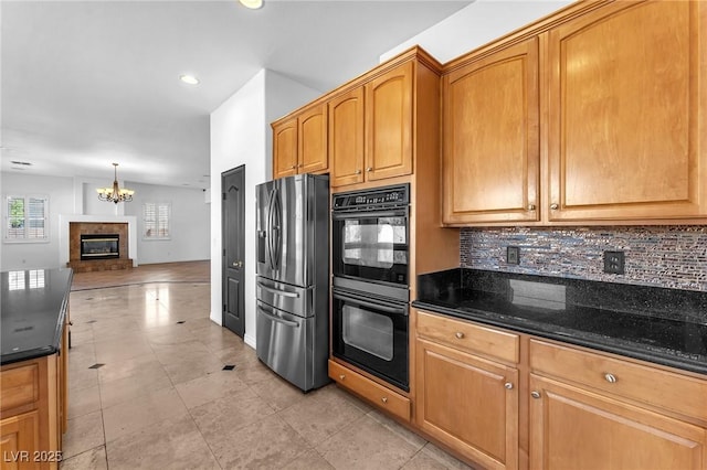 kitchen with tasteful backsplash, dobule oven black, open floor plan, and stainless steel fridge with ice dispenser