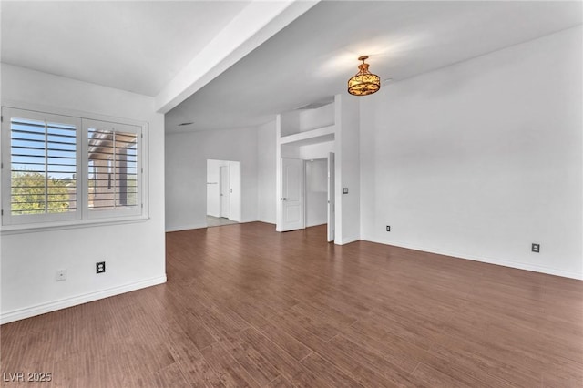 unfurnished living room with wood finished floors and baseboards