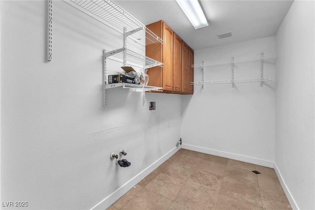 laundry area featuring visible vents, baseboards, gas dryer hookup, washer hookup, and cabinet space