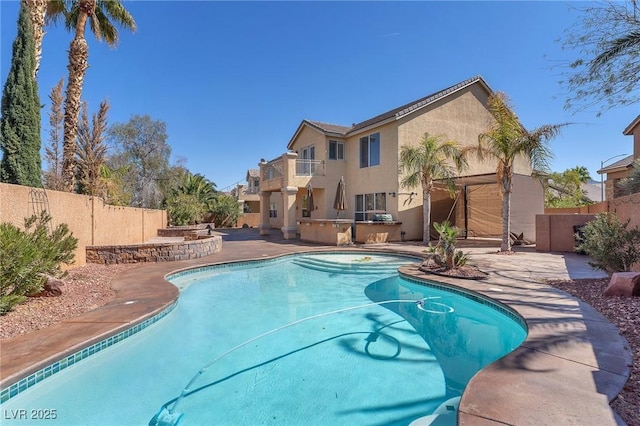 view of pool with a fenced in pool, an outdoor kitchen, a fenced backyard, and a patio area