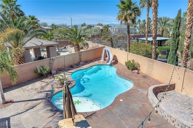 view of swimming pool featuring a gazebo, a fenced in pool, a water slide, and a fenced backyard