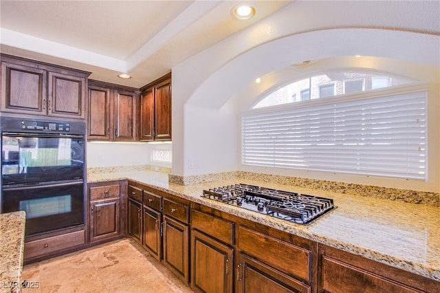 kitchen featuring light stone counters, gas cooktop, recessed lighting, and dobule oven black