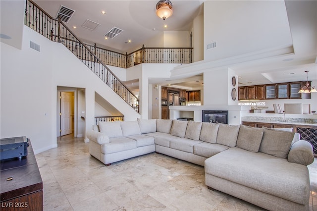 living area with visible vents and stairway